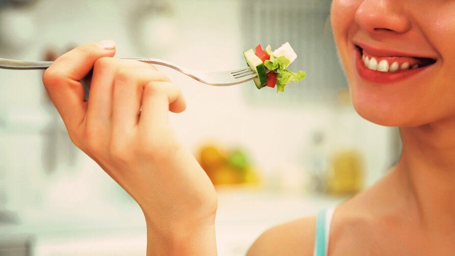 woman eating salad